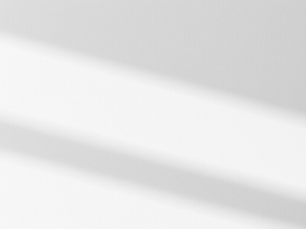 An architectural close-up of a curved, custom plaster staircase, its smooth, off-white finish accentuated by a wooden handrail in light walnut. The space is atmospheric, with soft, indirect daylight from a skylight above softly tracing the organic contours of the stair. Shadows and highlights interplay along the sweeping forms, emphasizing the craftsmanship and sculptural quality. The scene feels inspiring and quietly dramatic, with a sense of movement and flow. Captured from a low-angle perspective to enhance the staircase’s sculptural elegance, and composed with minimalist clarity, suitable for a portfolio highlighting unique interior architecture.